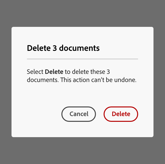 Example of a well-written confirmation dialog titled "Delete 3 documents," with body text reading "Select Delete to delete these 3 documents. This action can't be undone," and "Cancel" and "Delete" buttons — referring to the action by its label rather than its color or position.
