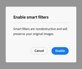 Key example of a confirmation alert dialog. Dialog title, Enable smart filters? Dialog description, Smart filters are nondestructive and will preserve your original images. Two calls to action, Cancel and Enable.