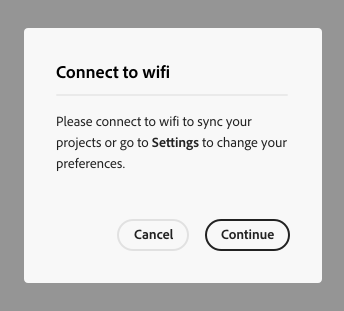 Key example of an information alert dialog. Dialog title, Connect fo wifi. Dialog description, Please connect to wifi to sync your projects or go to Settings to change your preferences. Two calls to action, Cancel and Continue.