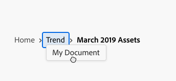 Key example of drag and drop into breadcrumbs, with items Home, Trend, and March 2019 Assets. Cursor dragging item My Document over drop target of breadcrumbs item Trend.