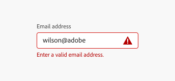 Key example of a text field, correctly communicating an error with both red color, an alert icon, and an in-line text alert. Text field label, Email address. Input text, wilson@adobe. Error message, Enter a valid email address.