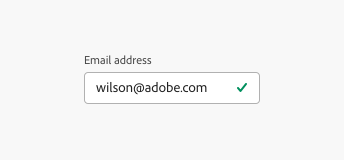 Key example showing a validated email text field with the label "Email address" and the typed in email address user@adobe.com. A green checkmark is placed in the right side of the field.